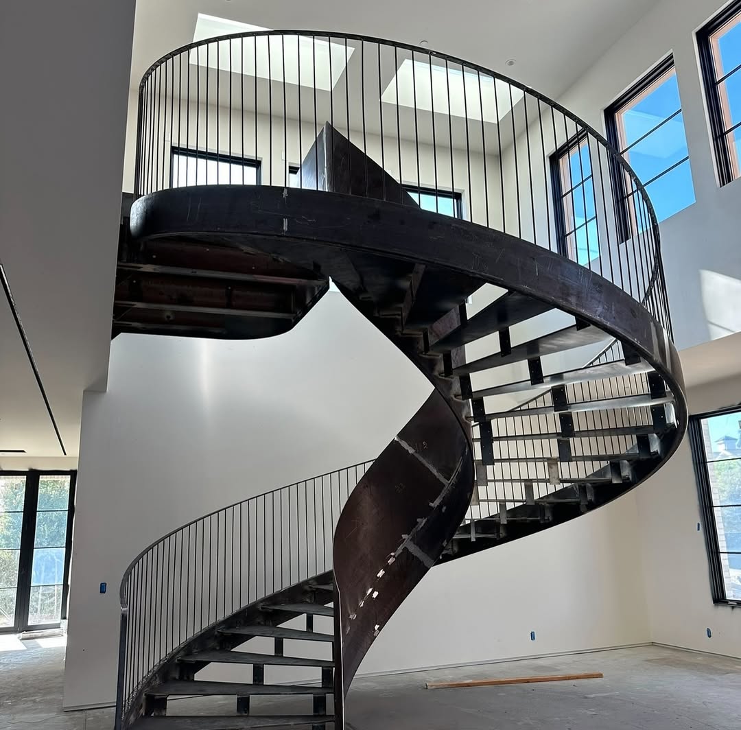 Modern spiral staircase in steel with minimalist vertical balustrades - about staired in london