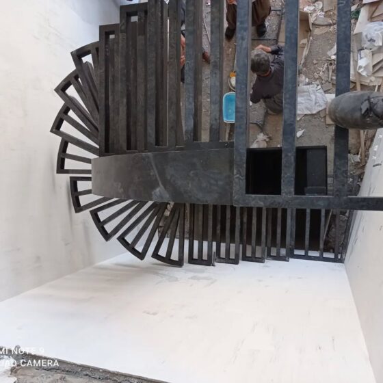 Top-down view of bespoke steel spiral staircase under construction