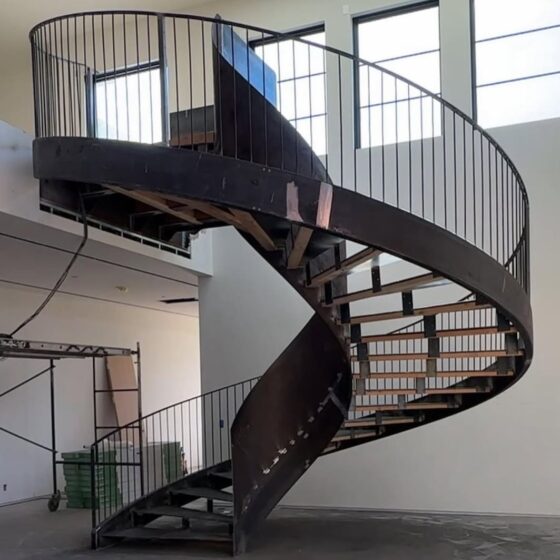 Elegant black steel spiral staircase with slim balustrades in duplex home