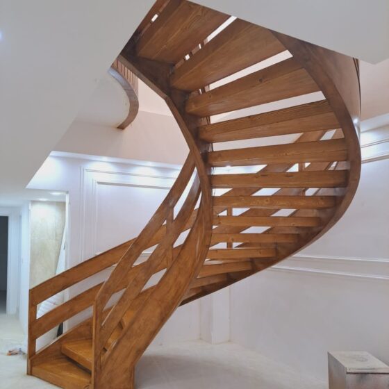 Custom wooden spiral staircase with warm finish and contemporary style