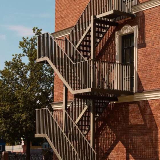 External steel fire escape staircase on traditional brick building - staircase compliance UK at Staired