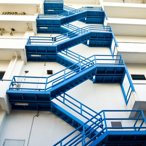 External blue steel fire escape staircase on building facade