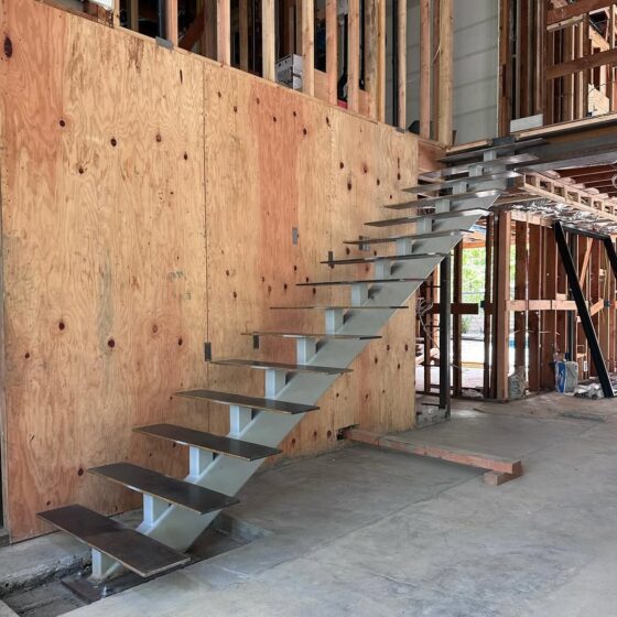 Floating cantilever staircase under construction with minimalist tread design in London property