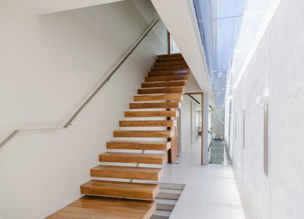 Modern floating cantilever staircase with solid timber treads and minimalist design in a London home
