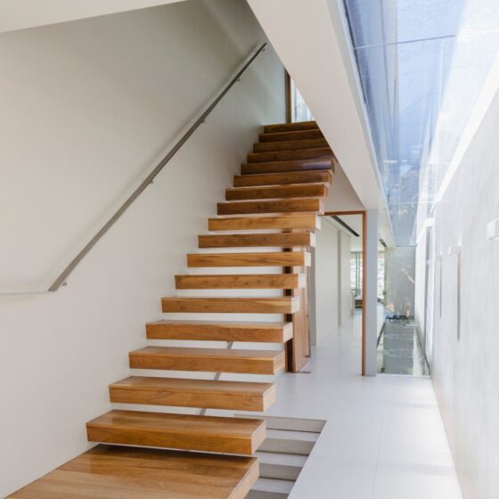 Modern floating cantilever staircase with solid timber treads and minimalist design in a London home