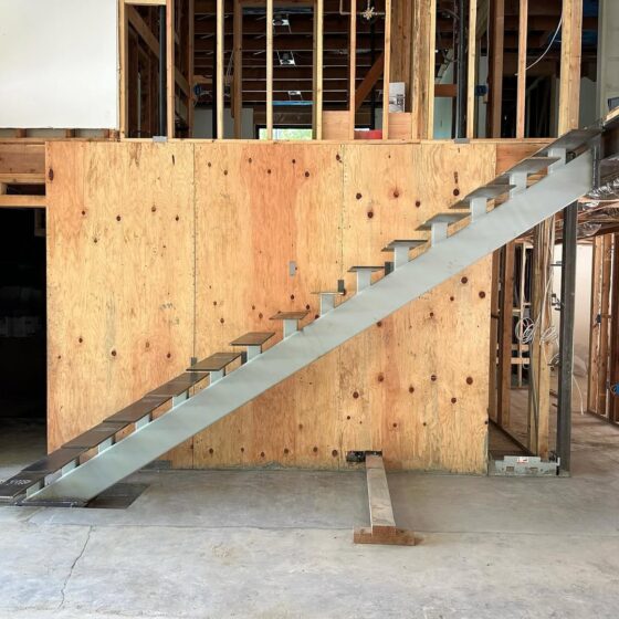 Steel frame installation for floating cantilever staircase during construction in a London property