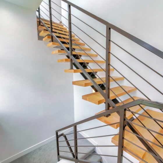 Modern floating staircase with open risers and steel balustrade in a contemporary London home