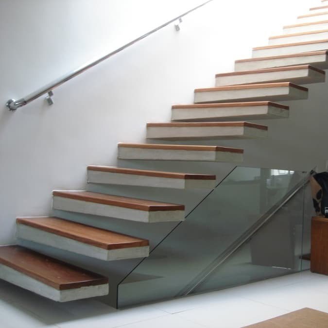 Floating staircase with steel balustrade and timber treads in a modern London interior