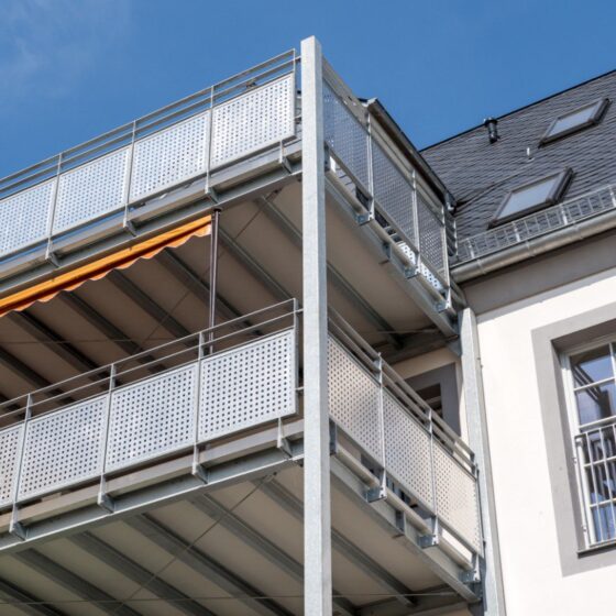 Galvanized steel balcony with perforated metal panels for durability