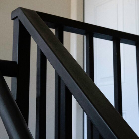 Close-up of minimalist black steel balustrade on staircase