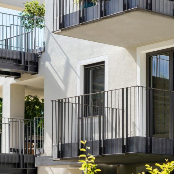Minimalist steel balcony railing on white modern apartment block