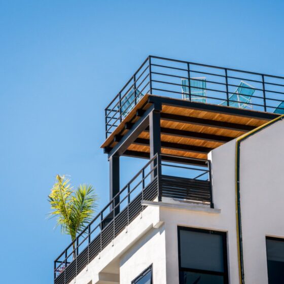 Contemporary steel balcony railing on rooftop terrace with outdoor seating