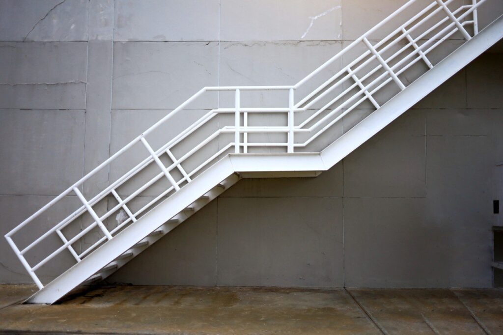 White external staircase with compliant railings and structure
