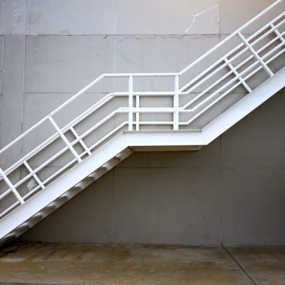 White external staircase with compliant railings and structure