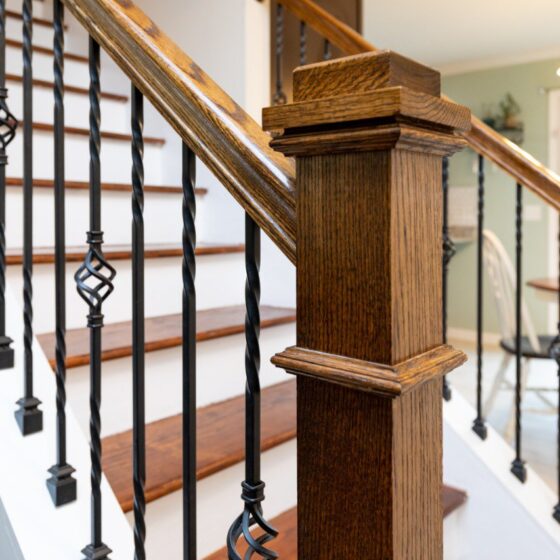 Detail of straight staircase with wooden post and metal balustrade for easy installation
