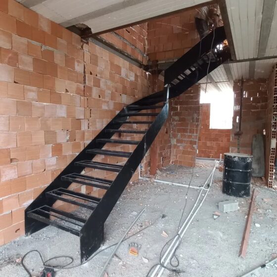 Straight metal staircase with open risers, black powder-coated stringers