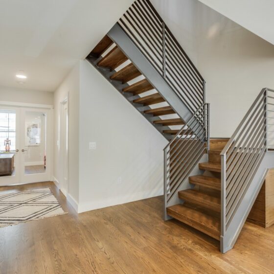 Straight staircase with wooden under-stair storage cabinets