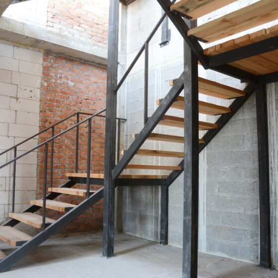 Industrial straight switchback staircase with steel frame and wooden treads