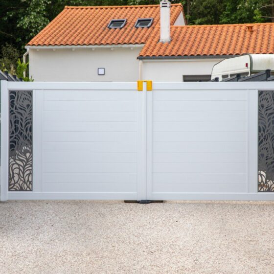 Contemporary white driveway gate with decorative side panels
